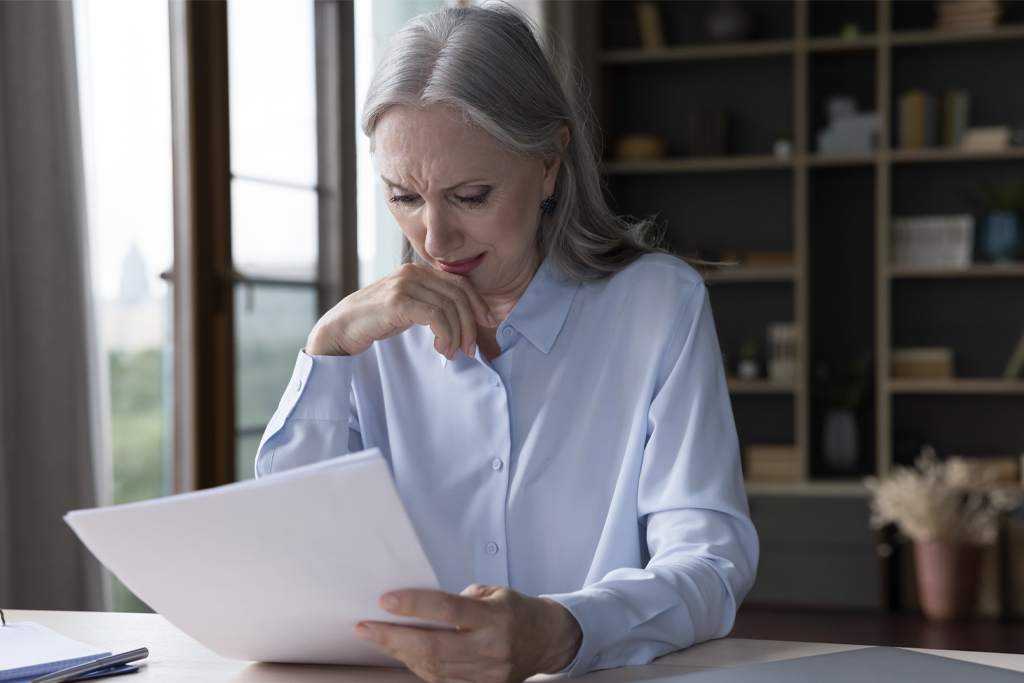 Old lady looking at paper